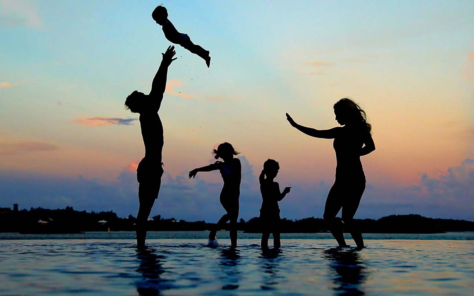 Bucket List family silhouette at sunset