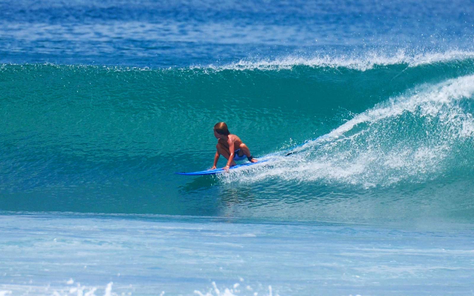 Child surfing a wave